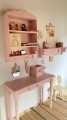 pink shelf with hangers for kids room