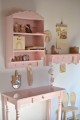 pink shelf with hangers for kids room
