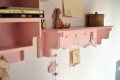 pink shelf with hangers for kids room