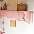 pink shelf with hangers for kids room